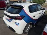 a white car with blue and red stripes parked in a parking lot