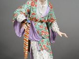 an antique figurine of a woman in a kimono dress