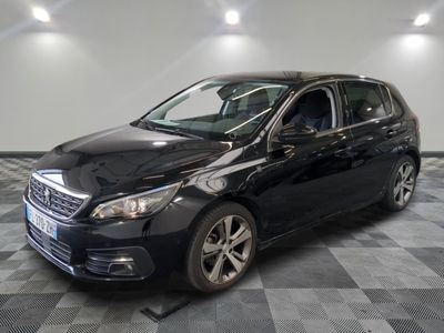 the black car is parked in the garage on a checkered floor