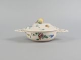 a white bowl with a bird on it sitting on top of a table