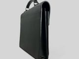 a black briefcase sitting on top of a white surface