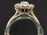 a close up of a diamond ring on a black surface