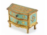 a small blue and gold chest of drawers on a white background