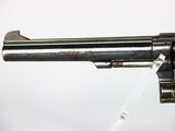 a close up of a revolver on a white surface with a white background