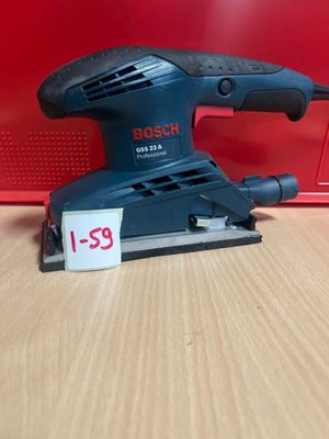 La ponceuse orbitale Bosch se trouve sur une table, à côté d'une boîte rouge.