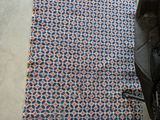 a blanket on the floor next to a stroller