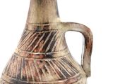 a brown and black vase with a handle on a white background