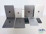 several ipads are lined up in a row on a white surface