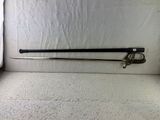 a sword that is laying on the floor in front of a curtain