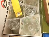 a box of empty wine glasses on a counter