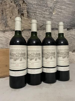 four bottles of wine are lined up on a table