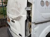 a white van that has been vandalized and is parked in a parking lot