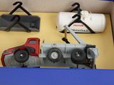 three toy trucks in a blue box on a table