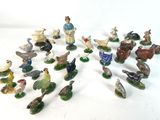 many figurines of different animals and birds on the table