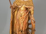 an image of a statue of a woman holding a staff