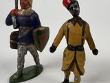 two figurines of a man and a woman dressed in medieval clothing
