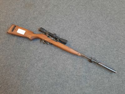 a rifle that is laying on the ground with a gun in it
