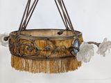 a hanging basket with flowers and a butterfly on it