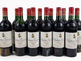 six bottles of red wine lined up in a row on a white surface