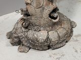 a statue of an elephant sitting on top of a table