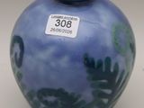 a blue vase with a blue lid sitting on a table