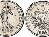 a close up of a coin with a woman on it