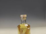 a small bottle of liquor sitting on a counter