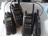 four motorola walkie talkies sitting on top of a white tray