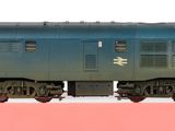 a toy train on a pink table with a white background
