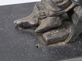 a statue of a person sitting on a book