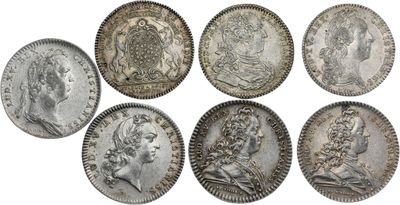 a group of six silver coins of various sizes and shapes