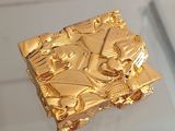 a gold object on display in a glass case