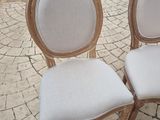 two chairs sitting next to each other on the sidewalk