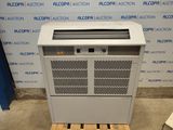 an air conditioner sitting on a pallet in front of a wall