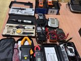 a table with a lot of electronics and other items on it