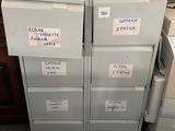 a stack of filing cabinets with labels on them