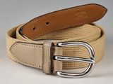 a belt with a metal buckle on it on a white surface