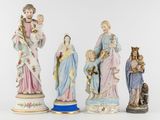 three figurines of the virgin and child with a dog and a cat