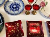 many plates and bowls on a table with a candle