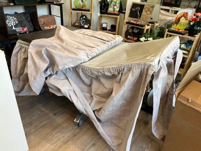 un lit recouvert d'un drap au milieu d'une pièce