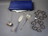 a blue box with silverware on it next to other silverware