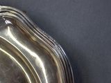 a silver tray with a handle on a black table
