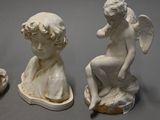 three white statues of angels sitting on top of each other