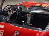 a red and black car with a steering wheel and dashboard