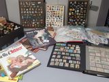 a table with a lot of stamps and books on it
