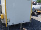 an image of a white and yellow trailer parked in a parking lot