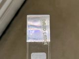 a clear plastic box with a sticker on it