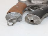 two revolvers that are sitting next to each other on a table
