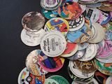 a pile of buttons on a table with a black background