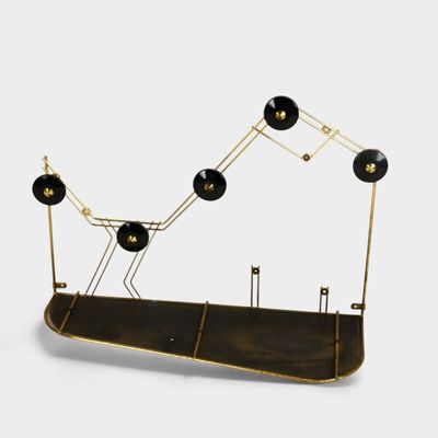 a black and gold sculpture with five lamps on it
